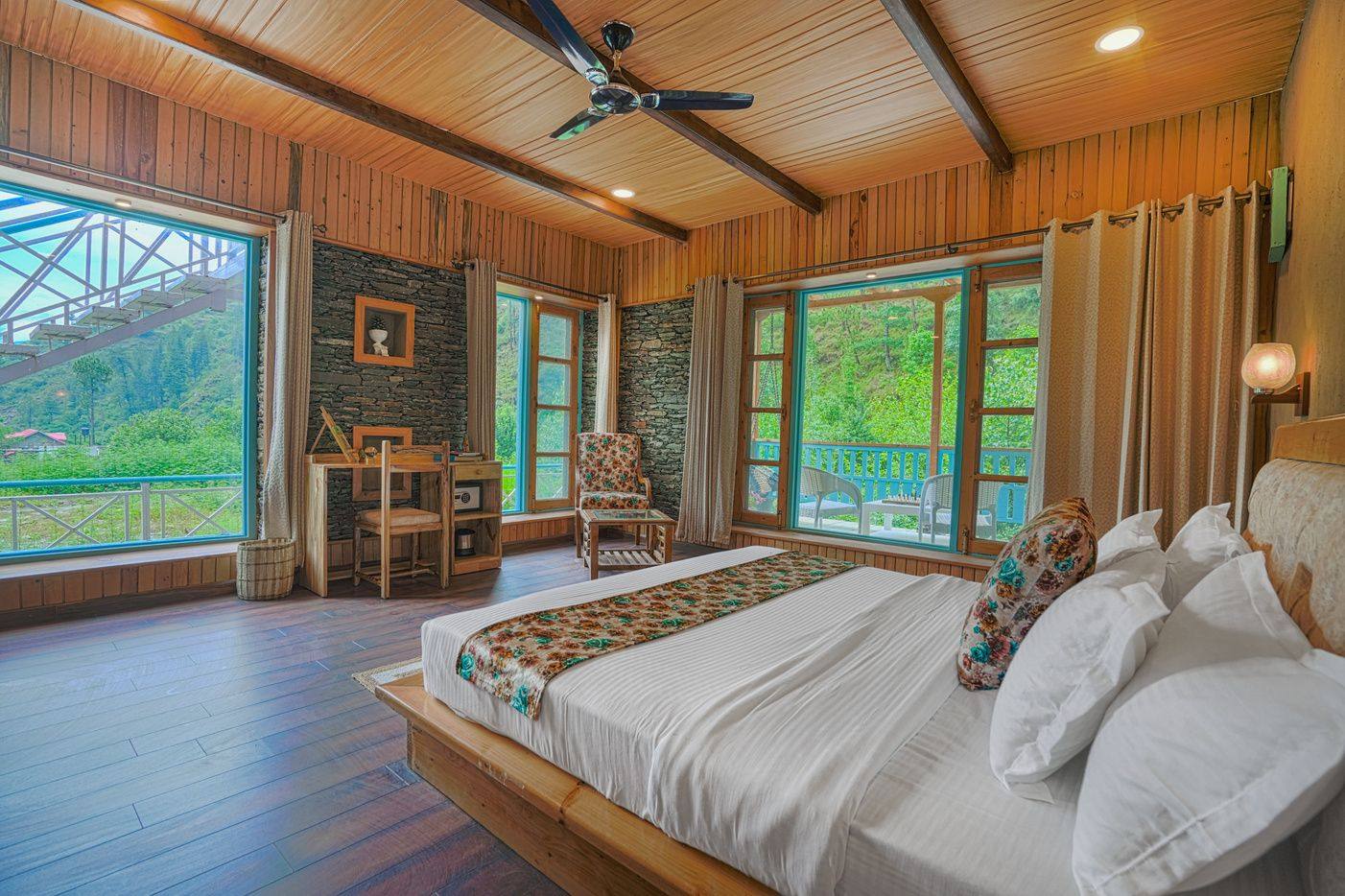 King bed room with large valley-view windows in Kaisdhara Villa