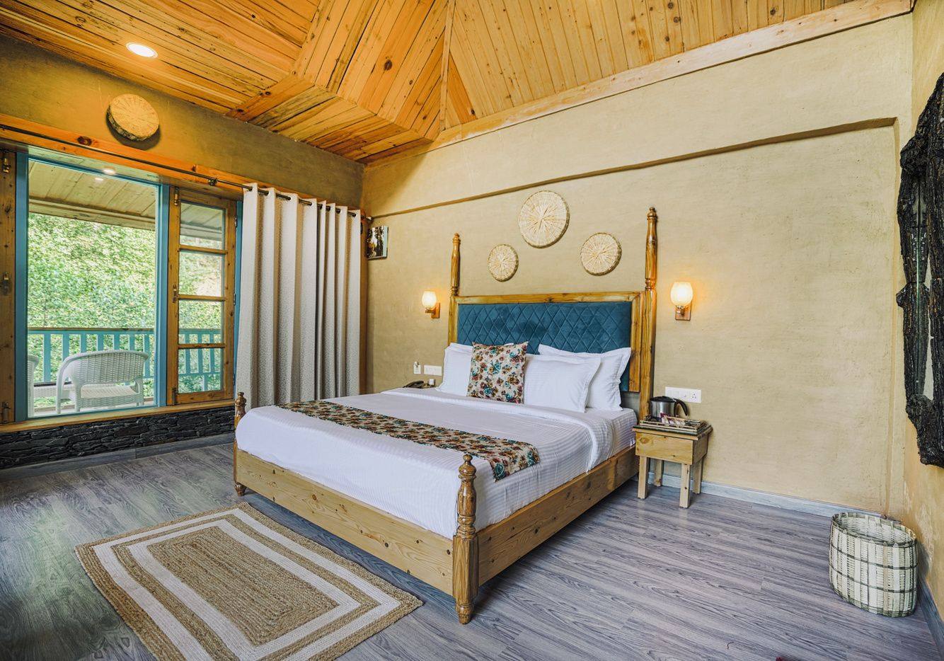 Room 102 full view with rug and wooden bed