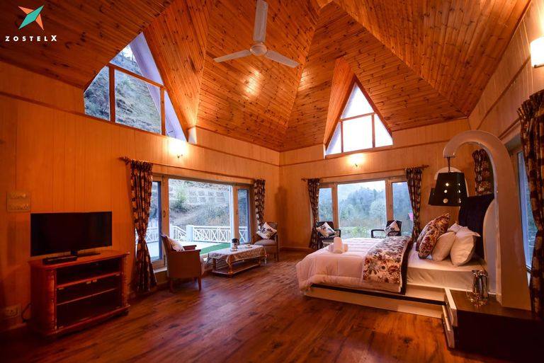 Holt-Loft bedroom under an A-frame timber ceiling