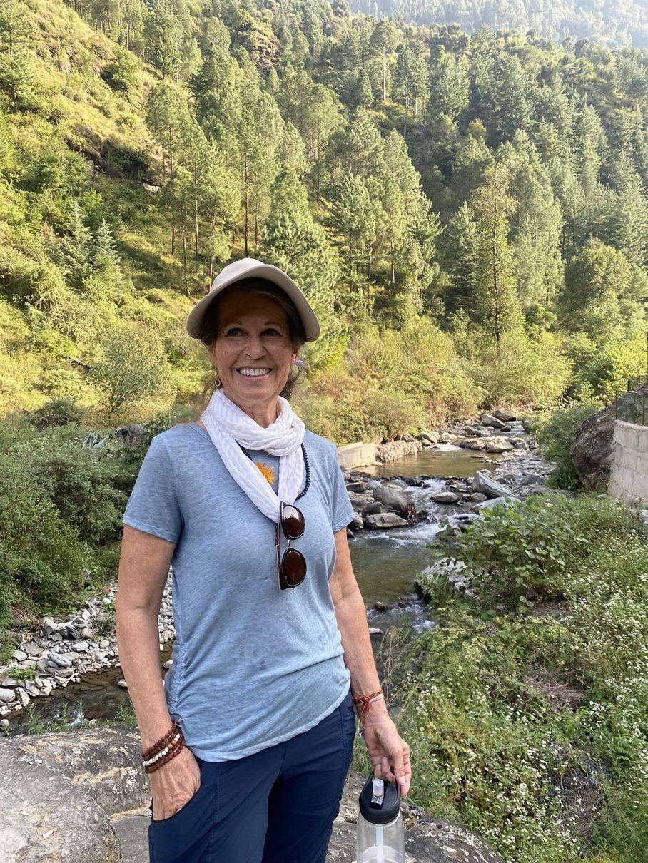 Hiker smiling on a mountain trail near Bhulang village