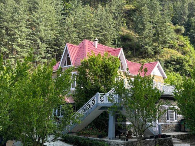 Orchard Villa with lawn and white staircase