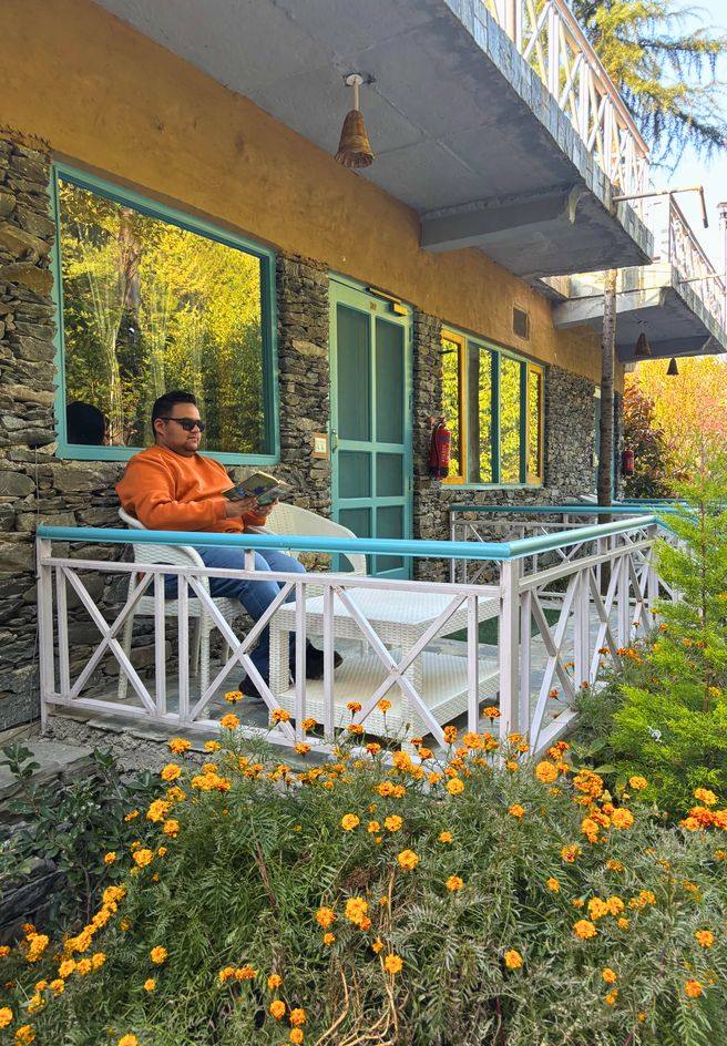 Guests relaxing on the Riveria verandah among marigolds