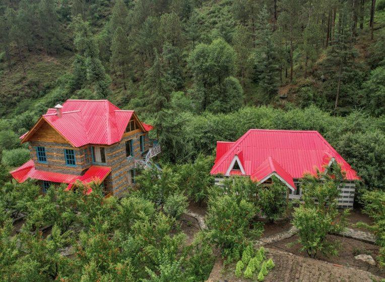 Red-roofed villas of Anandgram amid orchards