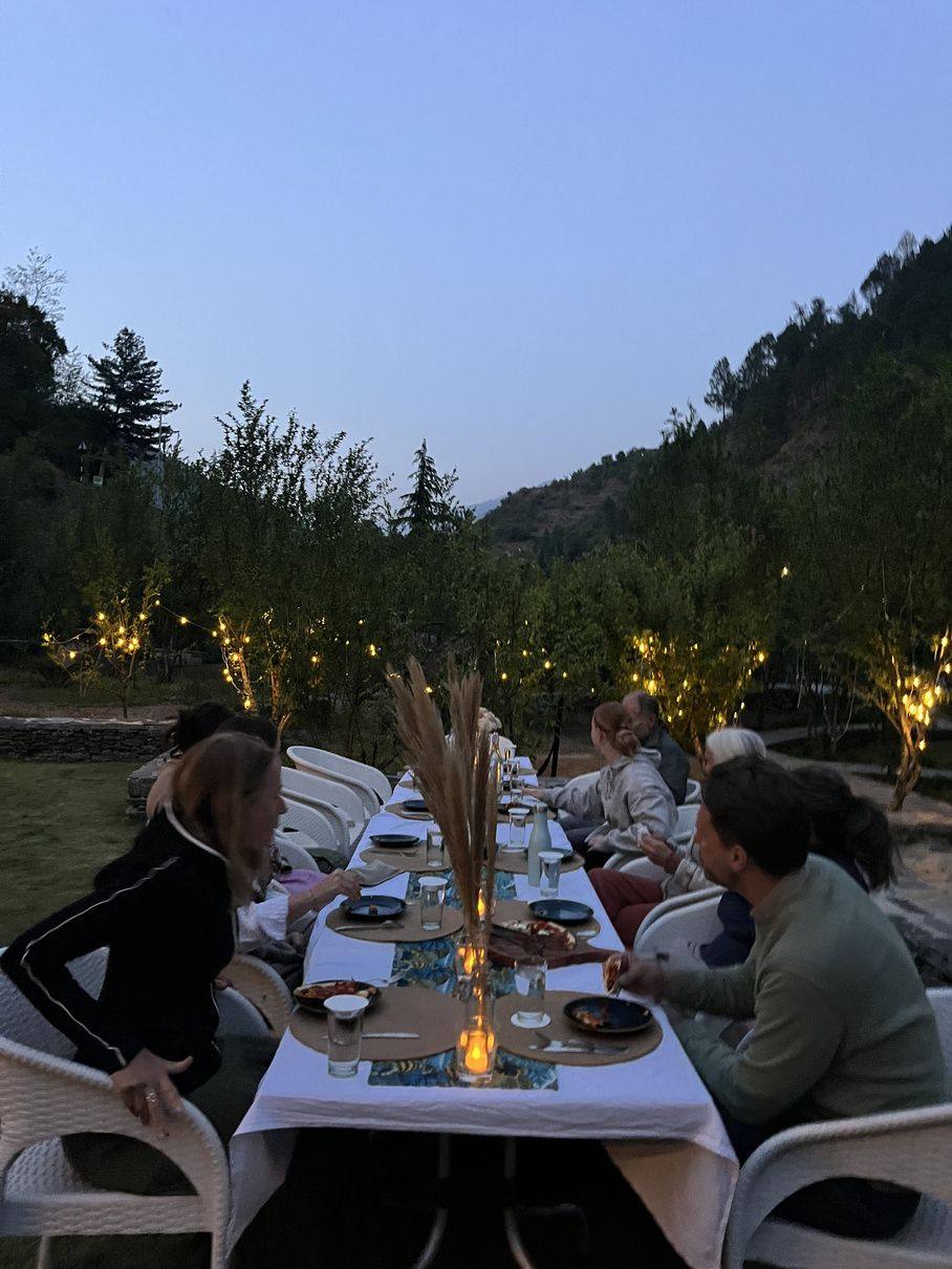 Candle-lit dinner on the lawn at dusk