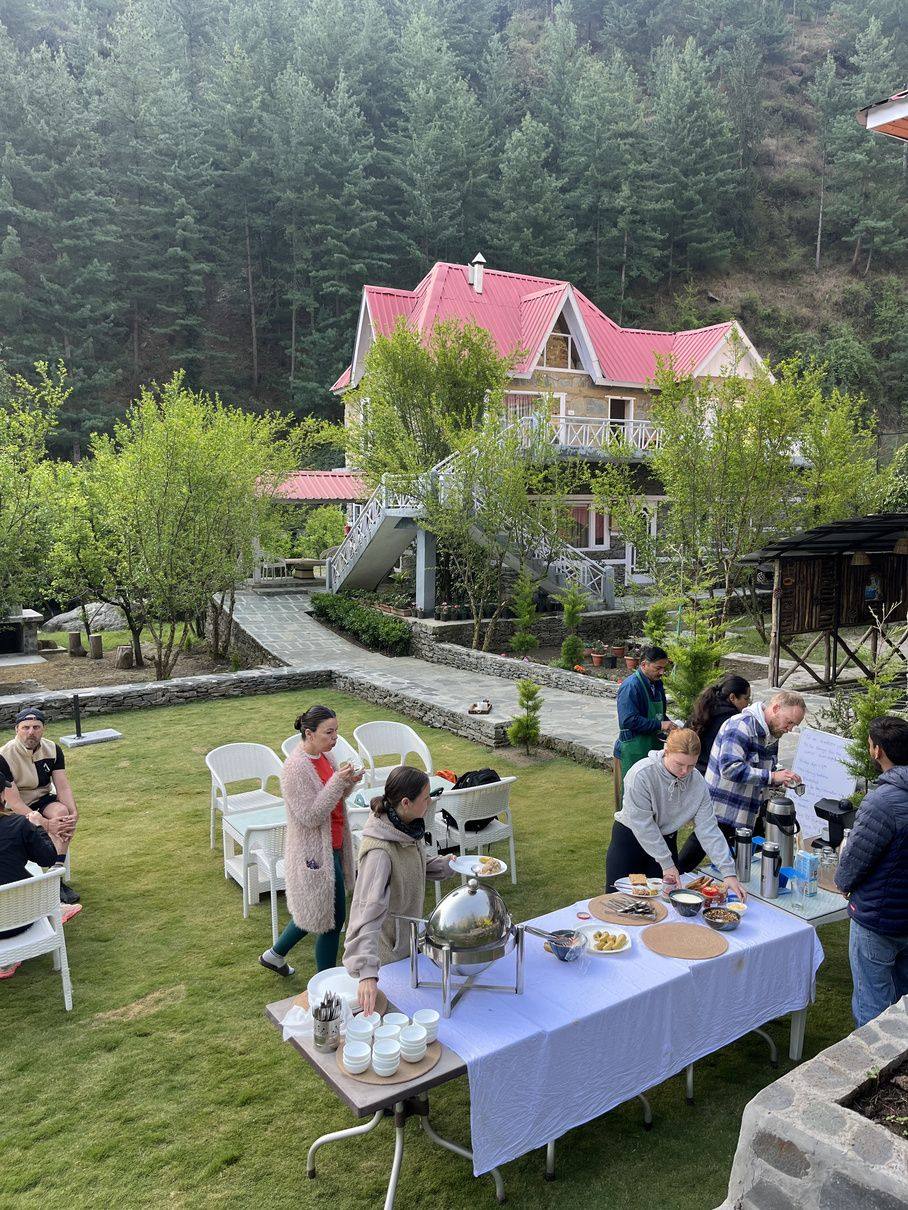 Lawn party with long table and villa behind