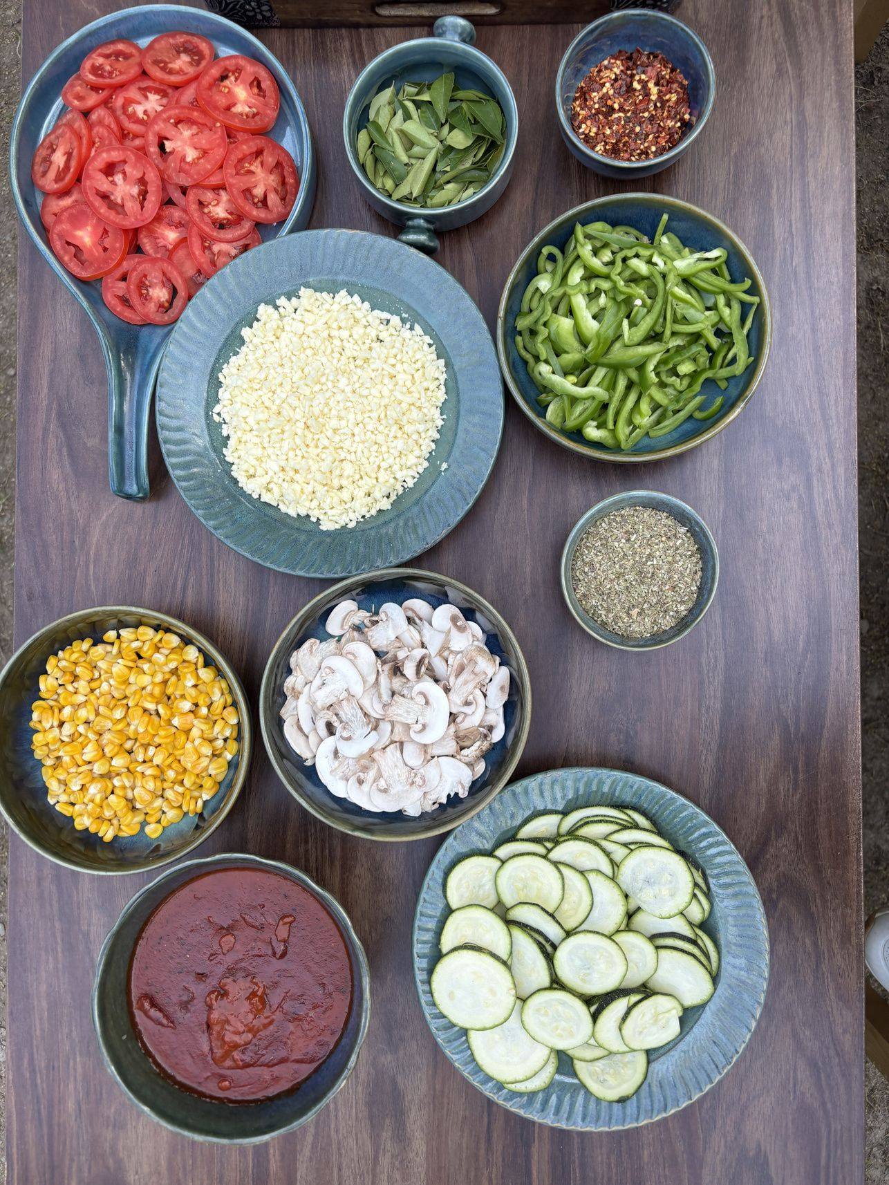 Fresh garden produce laid out for wood-fired pizza
